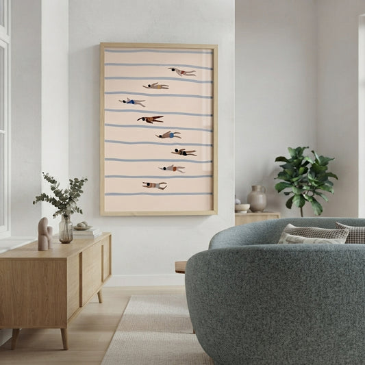 A framed Minimalist Swimming Pool Art Print with geometric swimmer illustration and Scandinavian design, hangs on a white wall in a modern living room. The print features a light beige background with thin blue horizontal stripes and several small birds in flight.