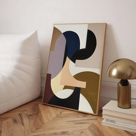 Abstract art piece on a wooden floor with a lamp and books in the background