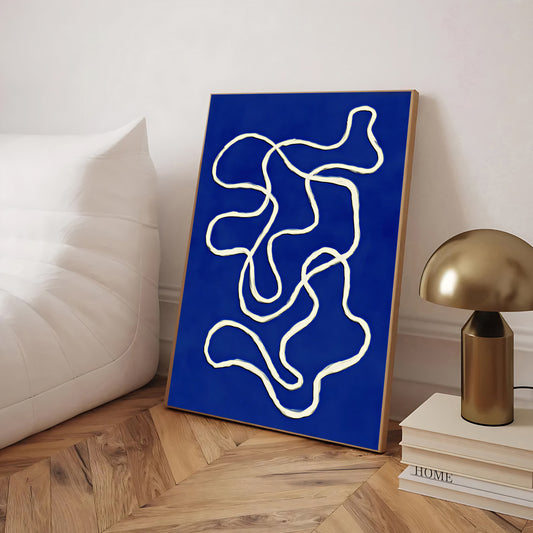 Abstract artwork with white lines on a blue background in a room setting.