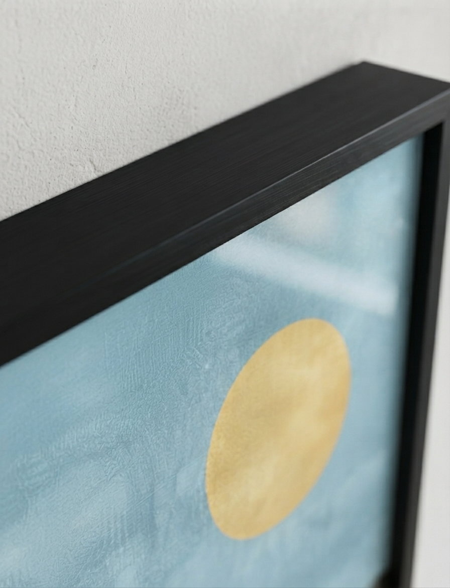 Close-up of a Bauhaus style swimming pool architectural print inspired by Palm Springs architecture featuring a textured light blue background with a large gold circular motif and a thick black frame against a white wall.