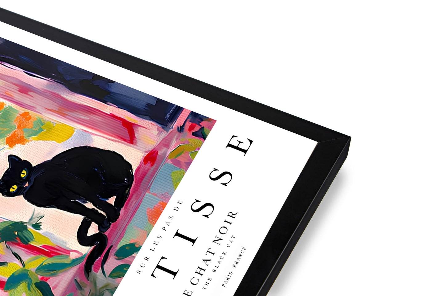 Framed black cat poster above modern interior table