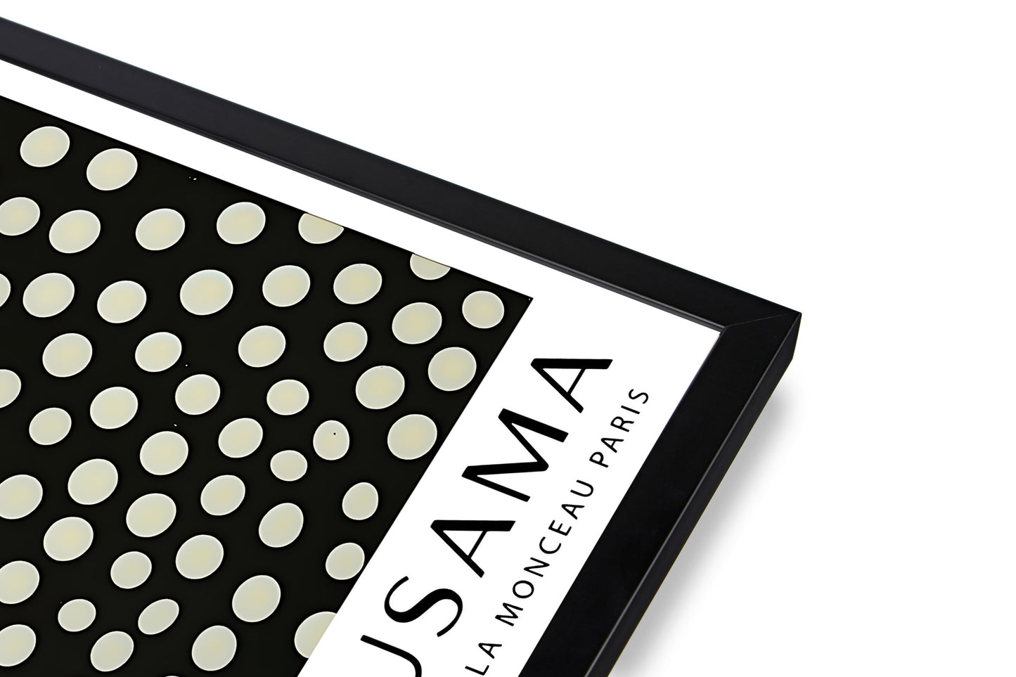 Close-up of black frame corner on Yayoi Kusama art print – premium framed wall art detail