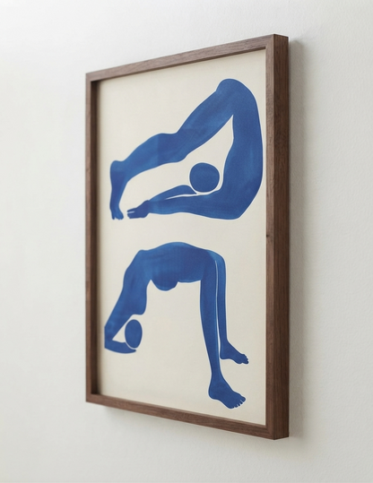 Framed Modern Blue Aesthetic Room Decor Print by PrintHausfeaturing two blue abstract human figure silhouettes on an off-white background, enclosed in a medium brown wooden frame and mounted on a light wall.