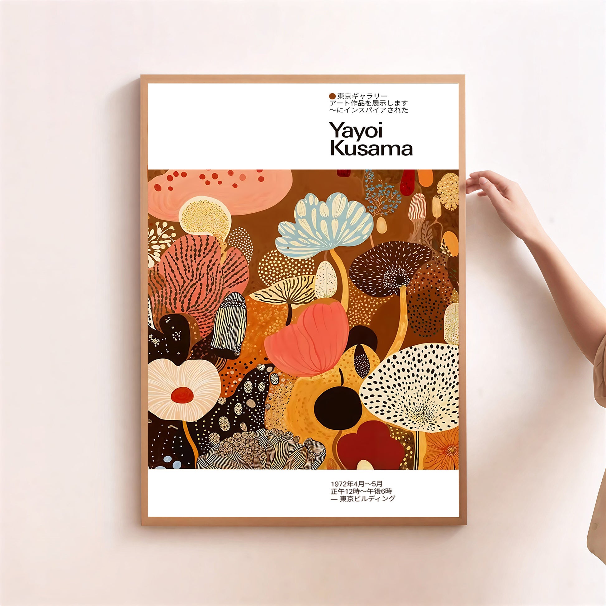 Framed Yayoi Kusama art print with colorful abstract design on a light pink wall.