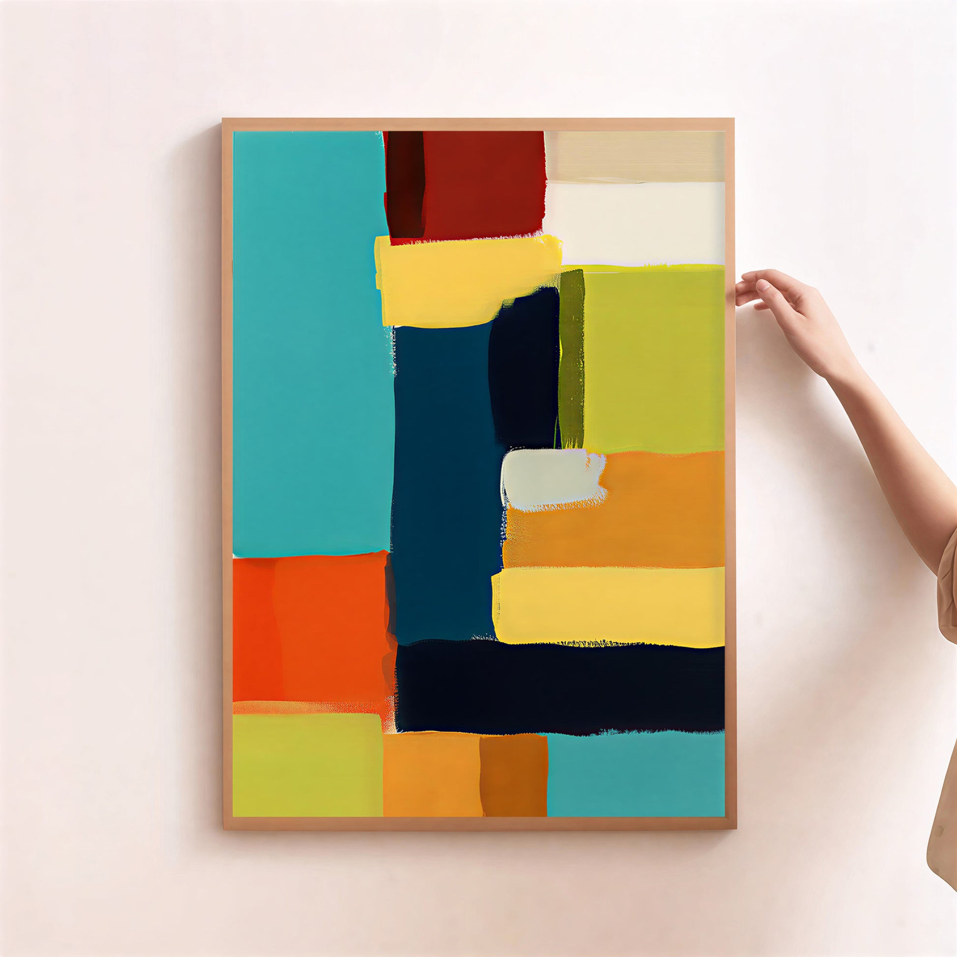 Abstract art print with colorful geometric shapes on a light pink wall.