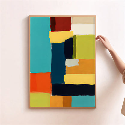 Abstract art print with colorful geometric shapes on a light pink wall.