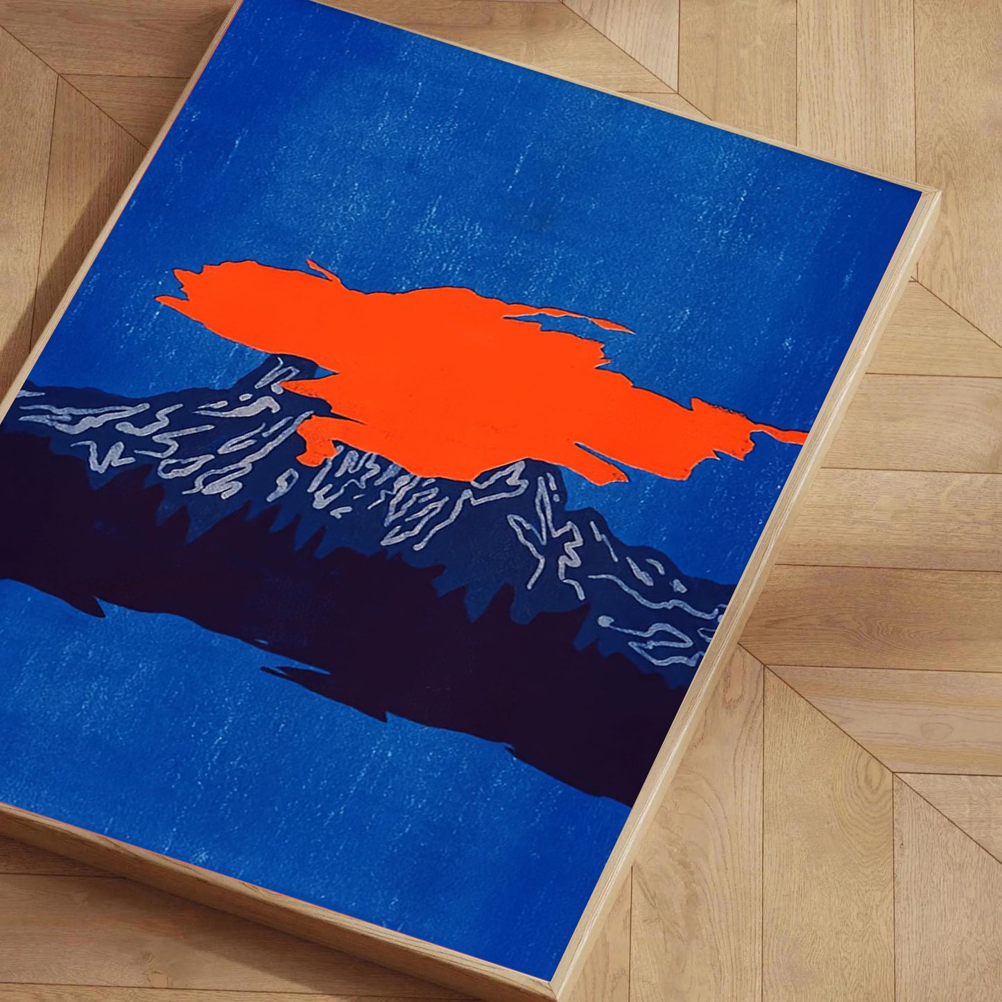 Abstract art piece with orange and black shapes on a blue background, displayed on a wooden floor.