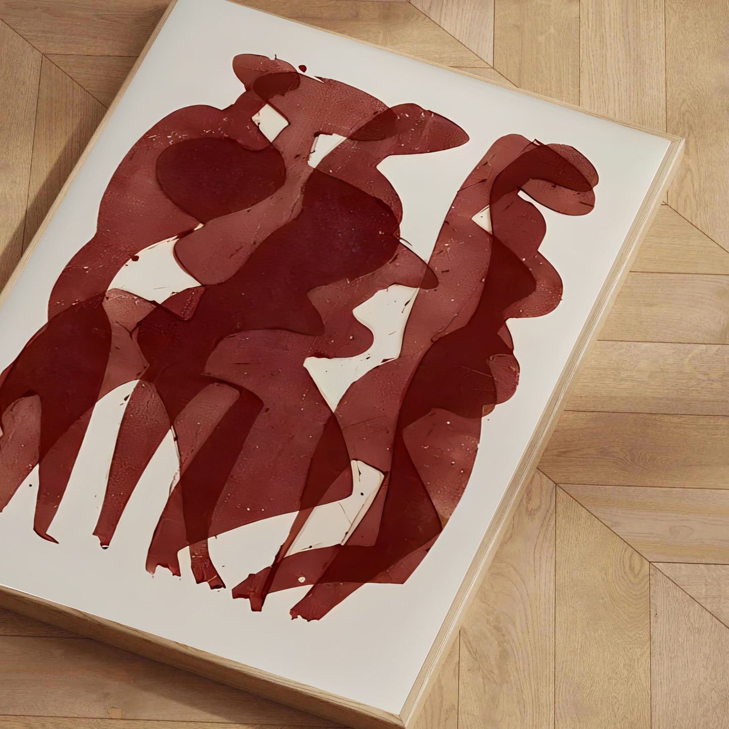 Abstract red artwork on a white background, placed on a wooden floor.