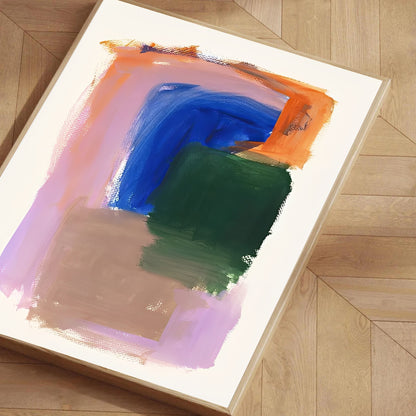 Abstract painting with colorful brush strokes on a light wooden floor.