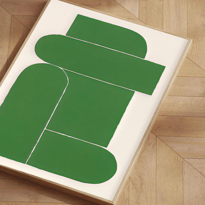 Green abstract art piece on a white background on a wooden floor