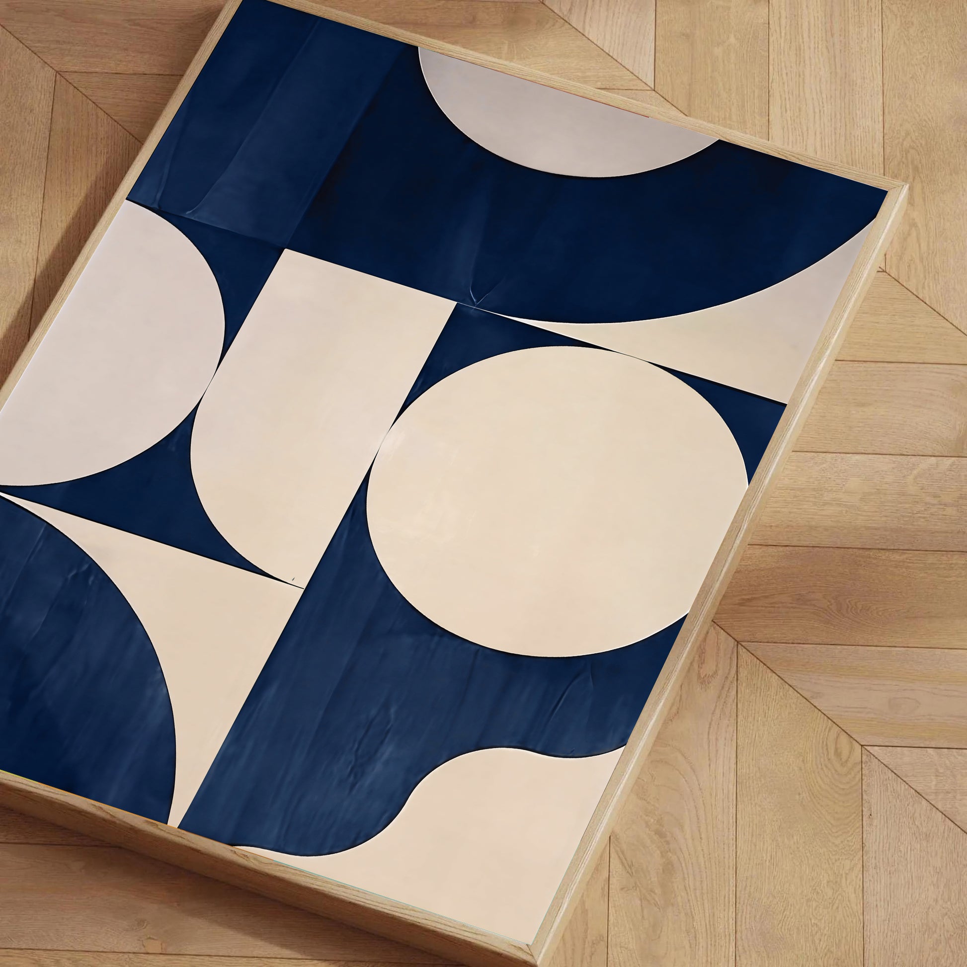 Geometric-patterned rug with blue and beige colors on a wooden floor