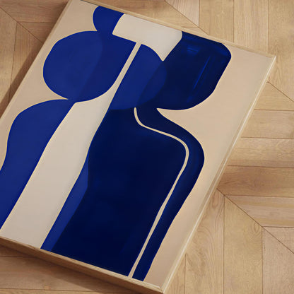 Abstract art piece with blue and white shapes on a beige background, displayed on a wooden floor.