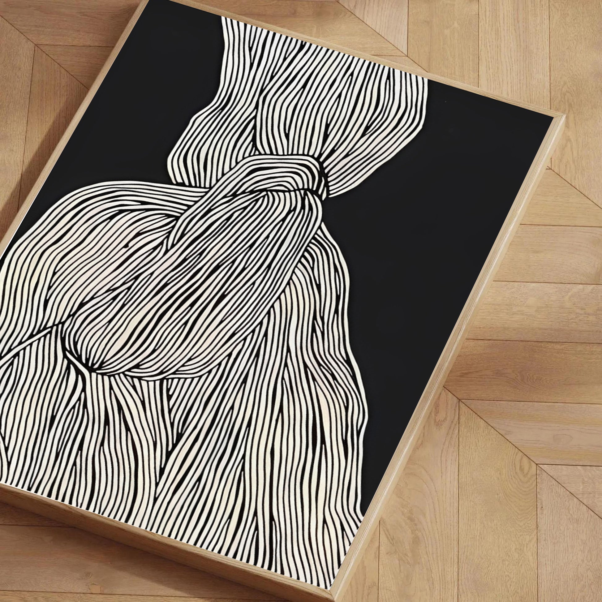 Black and white abstract rug on a wooden floor