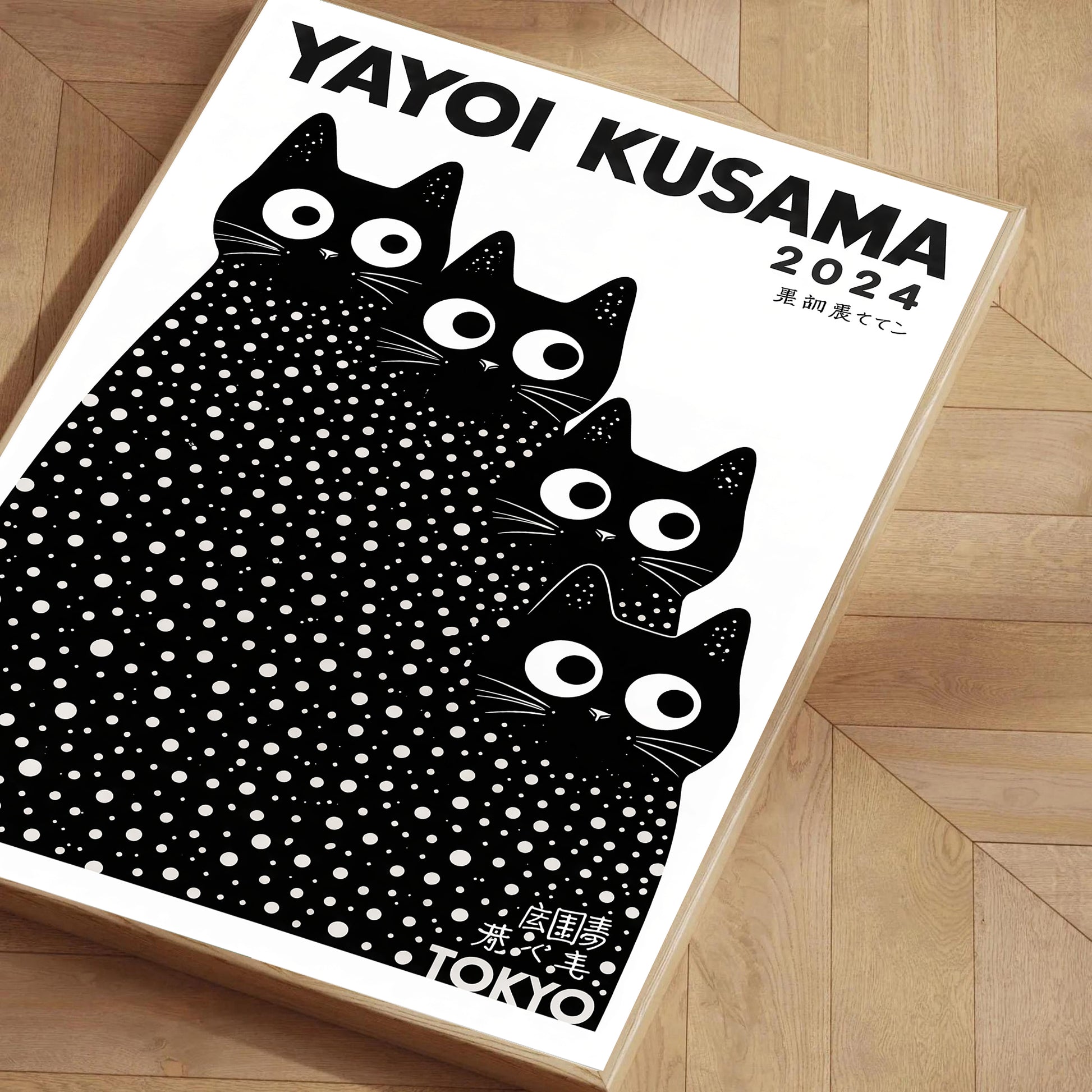 Yayoi Kusama 2024 calendar with black cat design on a wooden floor.