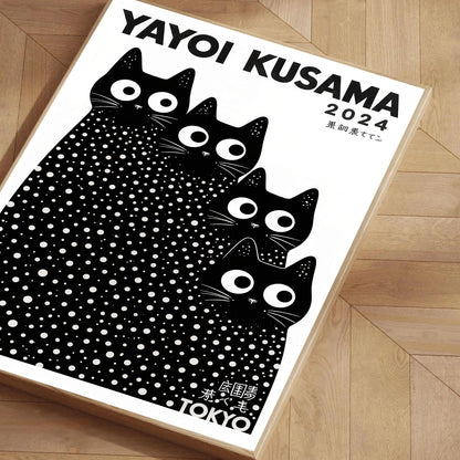 Yayoi Kusama 2024 calendar with black cat design on a wooden floor.