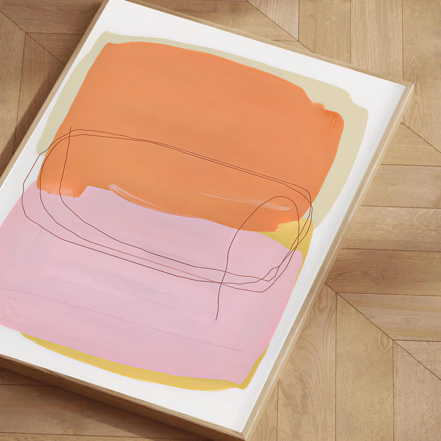 Abstract art print with orange, pink, and yellow colors on a wooden floor.
