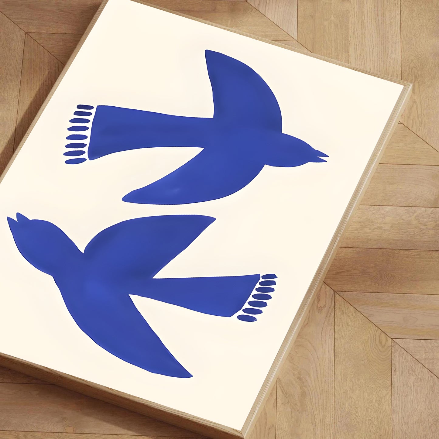Two blue birds on a white background in a wooden frame.