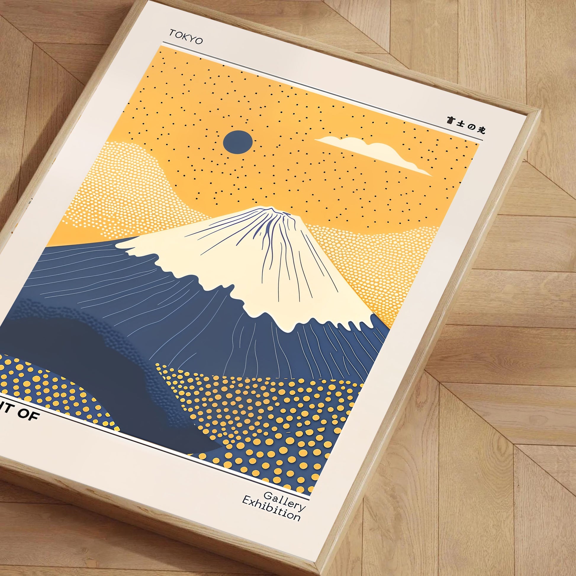 Framed poster of Mount Fuji with a yellow and blue design on a wooden floor.