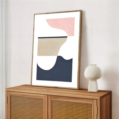 Scandinavian wall art print minimalist design in a wooden frame on a wooden cabinet with a white vase.