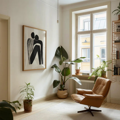 Modern living room with a brown armchair, plants, and abstract art on the wall.