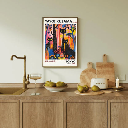 Colorful Yayoi Kusama black cats poster in a kitchen with wooden cabinets and a sink.