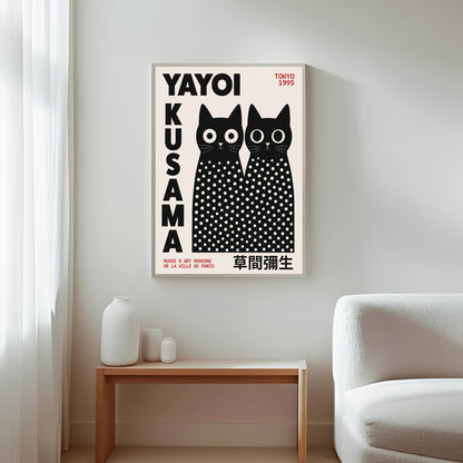 Framed Yayoi Kusama cats artwork with black and white polka dots on a wall in a living room.