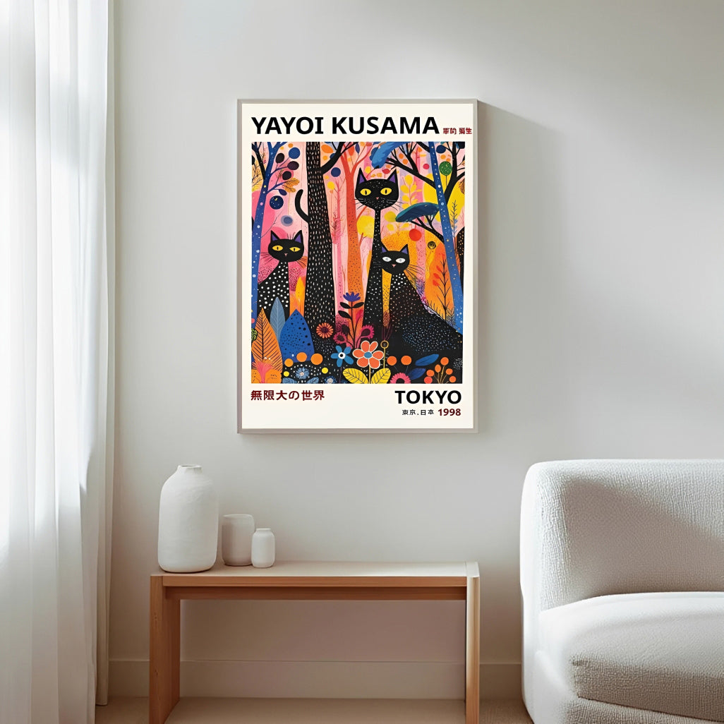 Framed Yayoi Kusama black cats artwork on a wall in a minimalistic room.