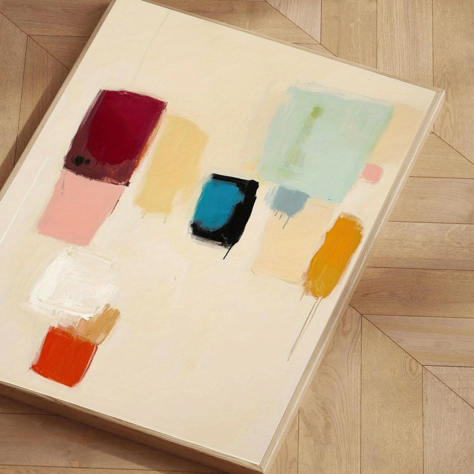 Abstract art piece with colorful shapes on a wooden floor