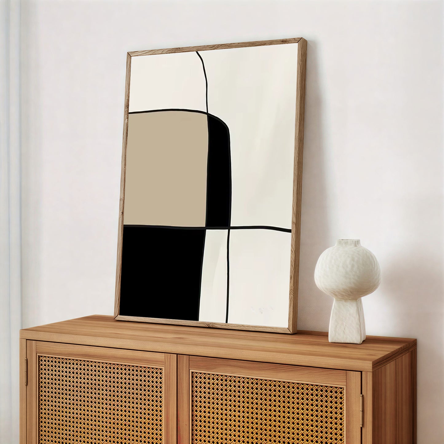 Wooden cabinet with a large mirror and a decorative vase on a white wall.