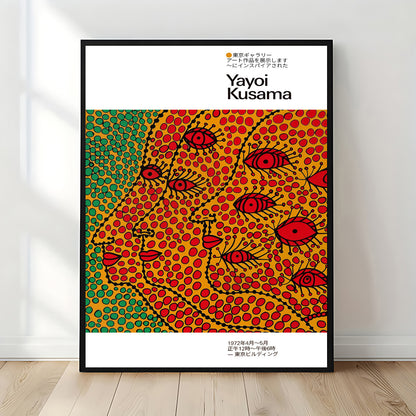 Yayoi Kusama–style framed poster with vibrant polka-dot abstract faces in red, yellow, and green, displayed upright against a sunlit white wall