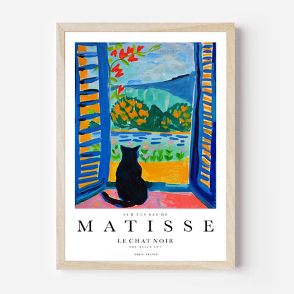 Framed Matisse art print of a cat by a window with colorful landscape.