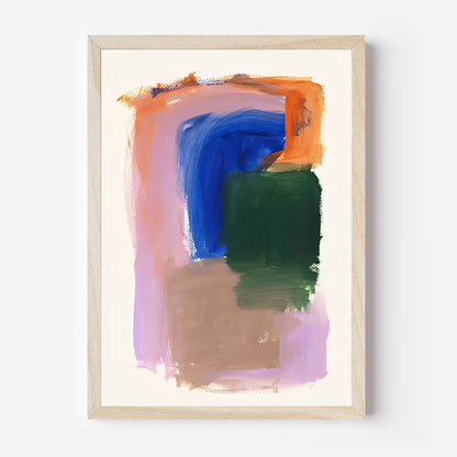 Abstract art print with colorful brush strokes in a wooden frame on a white wall.