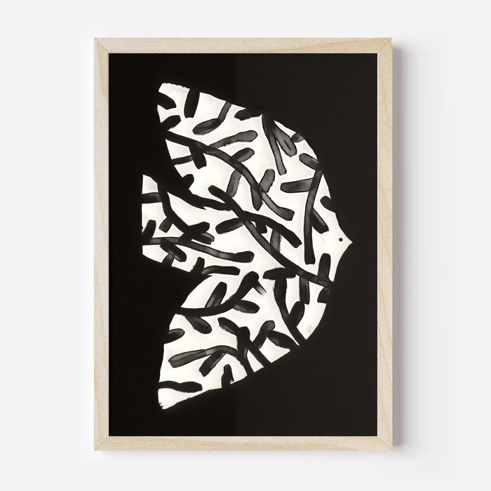 Framed abstract art print with black and white pattern on a black background