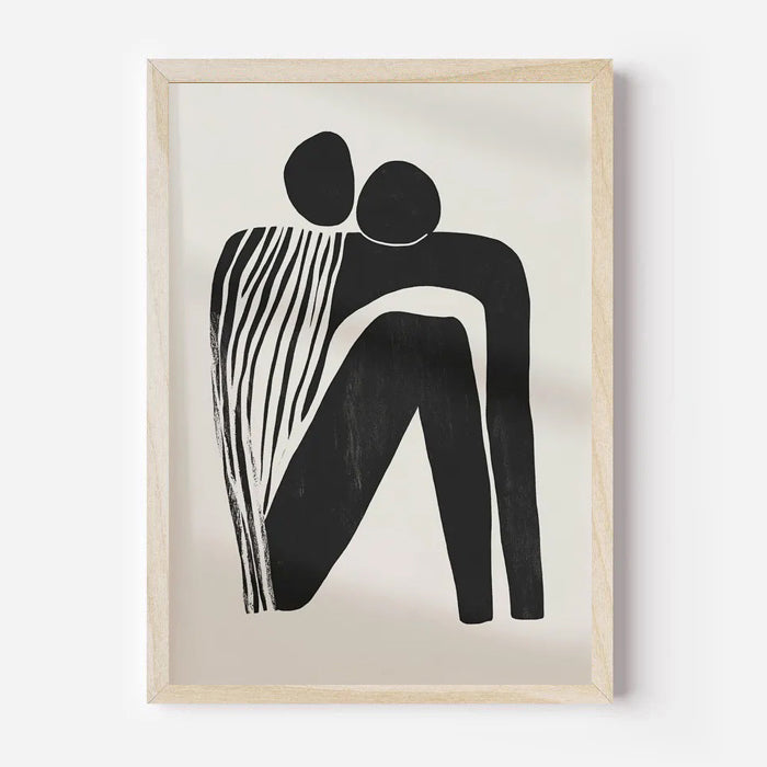 Framed abstract artwork of two black figures on a beige background