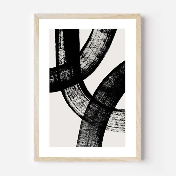 Framed abstract art print with black and white design on a white background