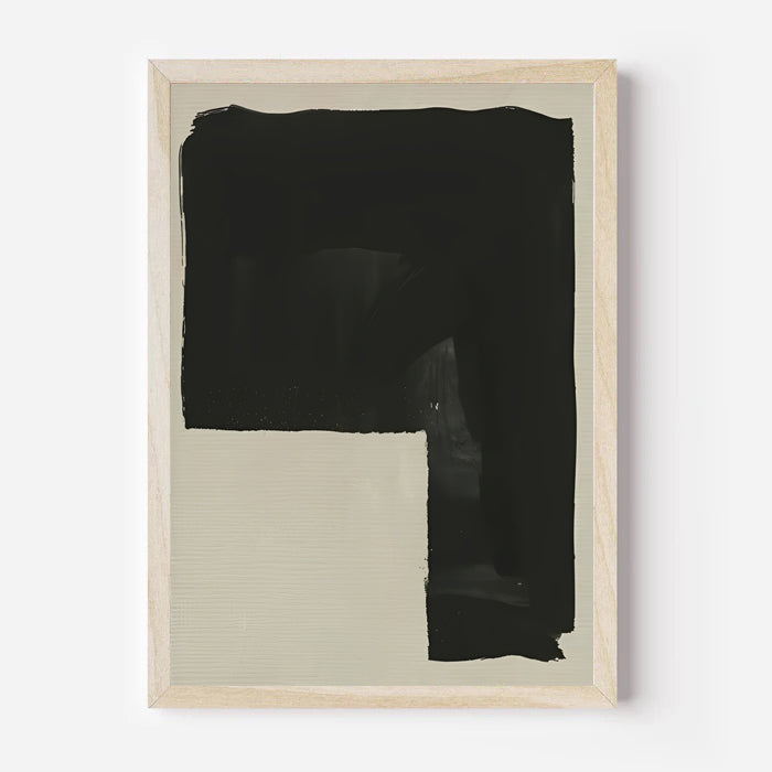 Framed abstract art piece with black and beige sections on a white background