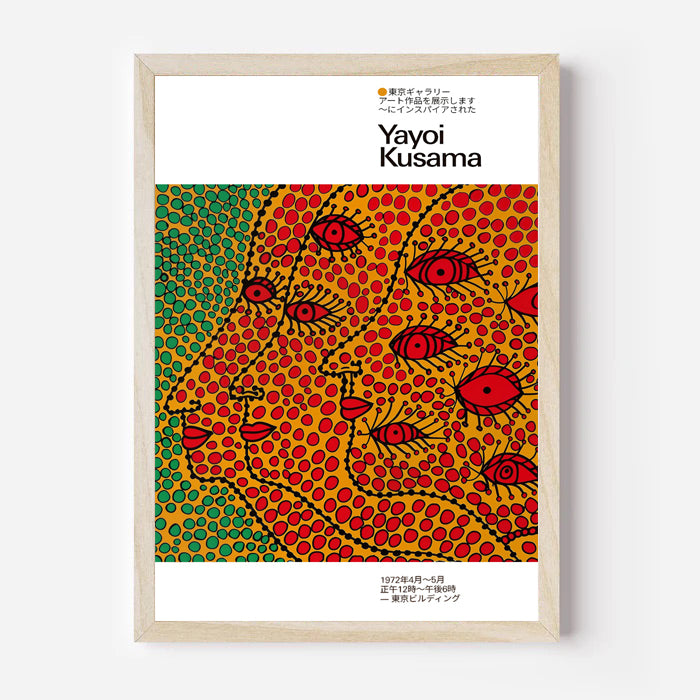 Yayoi Kusama art print featuring colorful dotted faces and red eyes displayed in a light wood frame