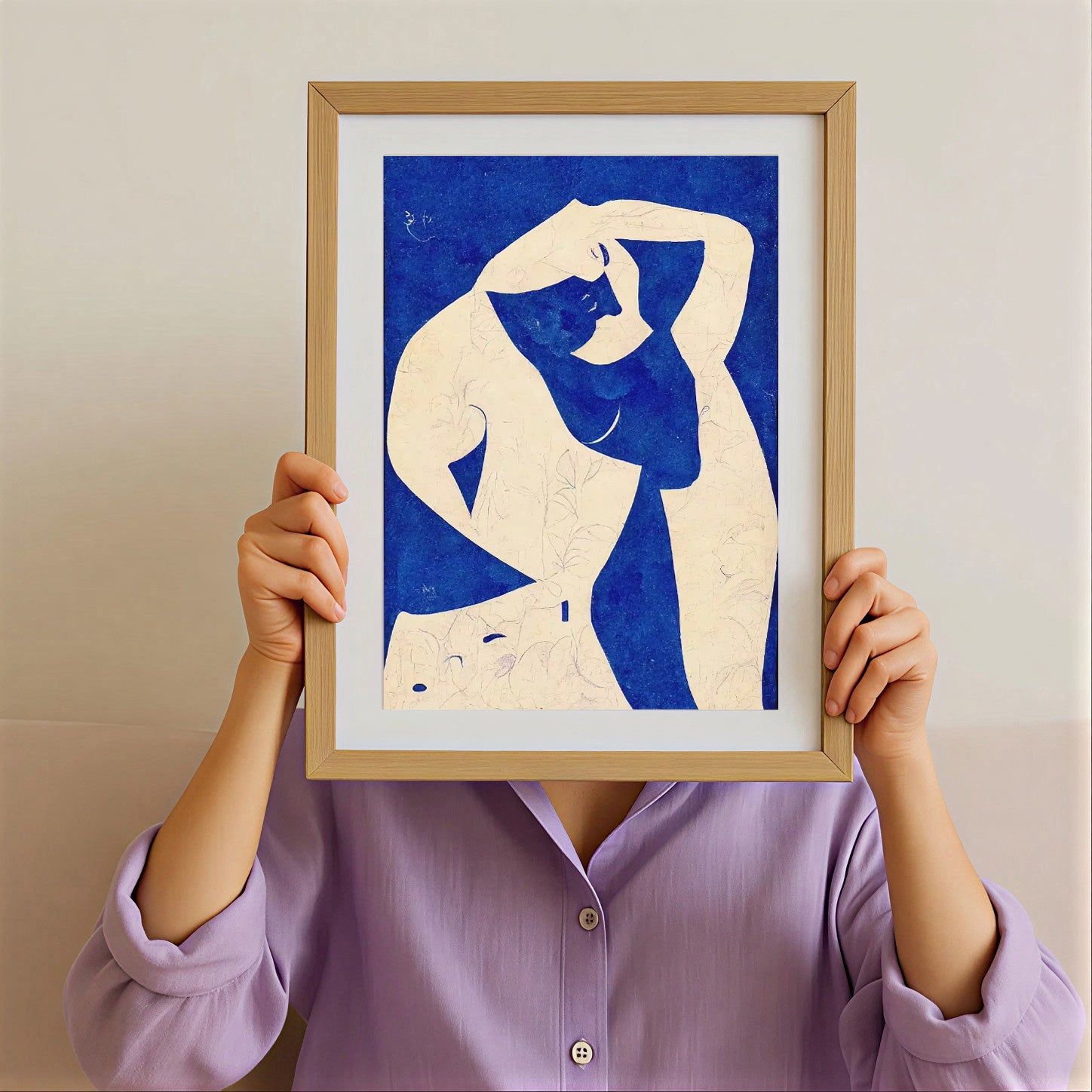 Person holding a framed artwork of a stylized human figure against a blue background.