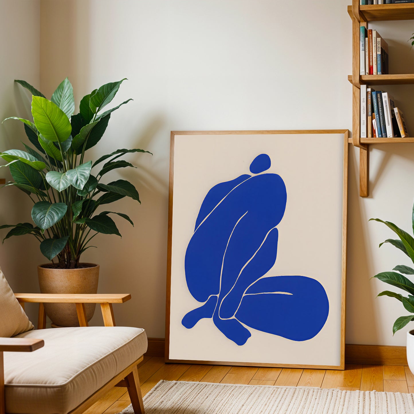Framed abstract artwork with blue figures in a living room setting.