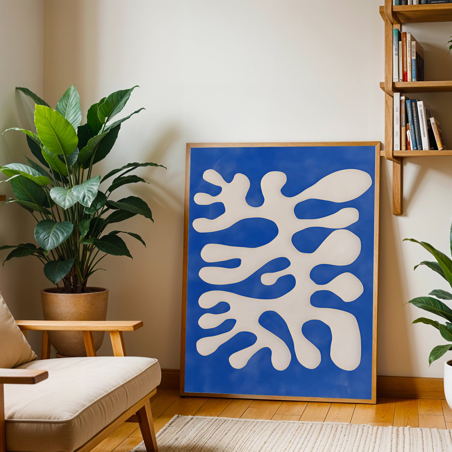 Modern living room with a blue abstract artwork, plant, and bookshelf.