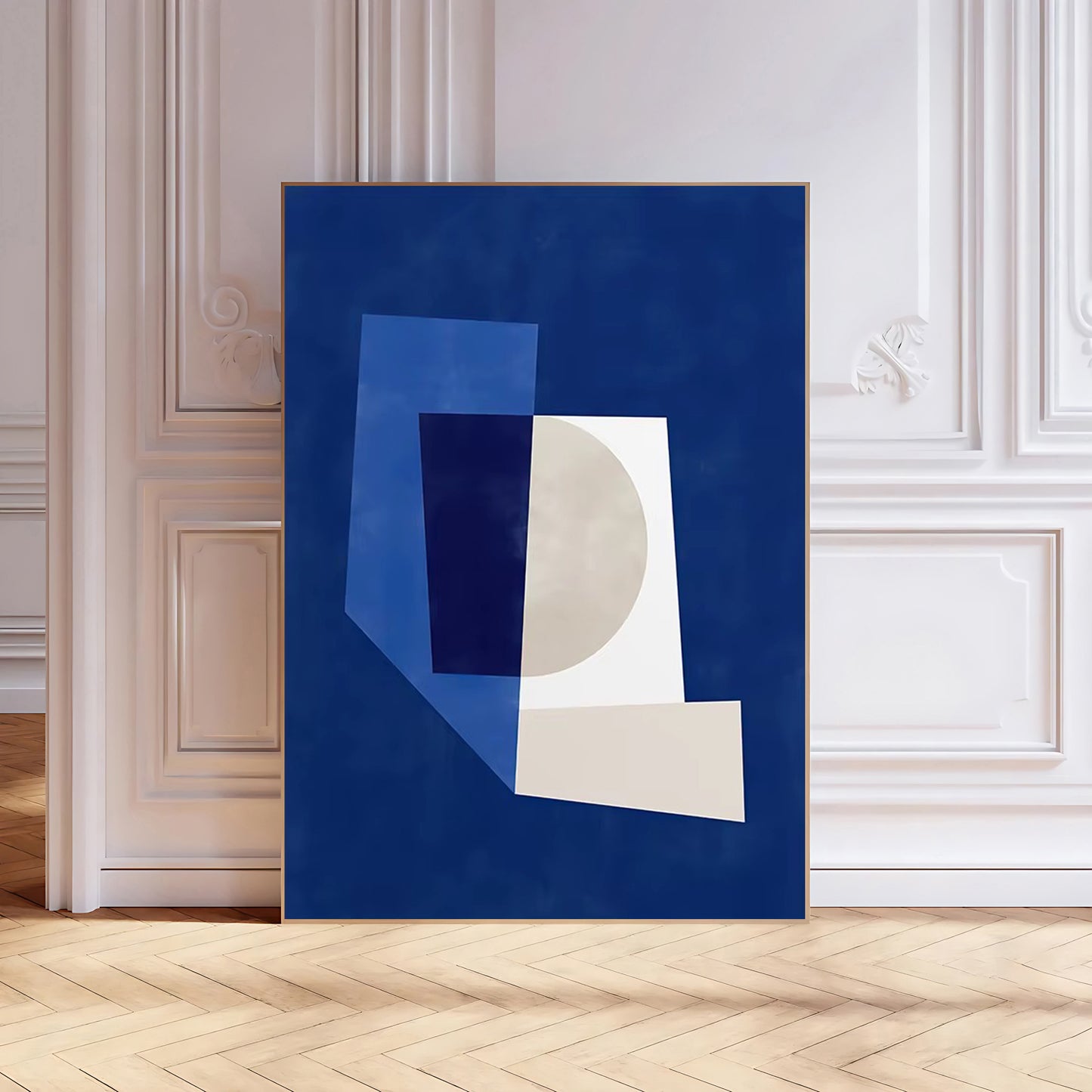 Abstract art print with geometric shapes on a blue background in a room with white walls and wooden floor.