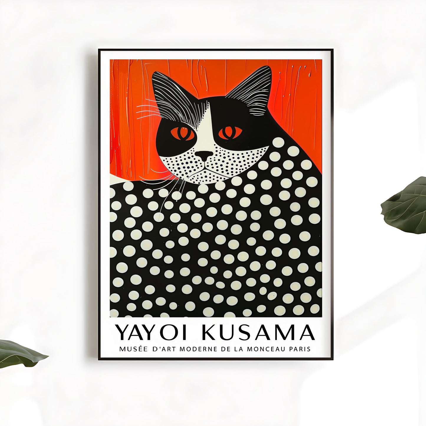 Framed Yayoi Kusama-style cat art print with bold orange background and white polka dots, hanging on a clean white wall with green leaves in view
