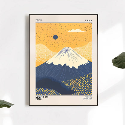 Framed artwork of Mount Fuji with a yellow sky and blue mountains on a white wall.
