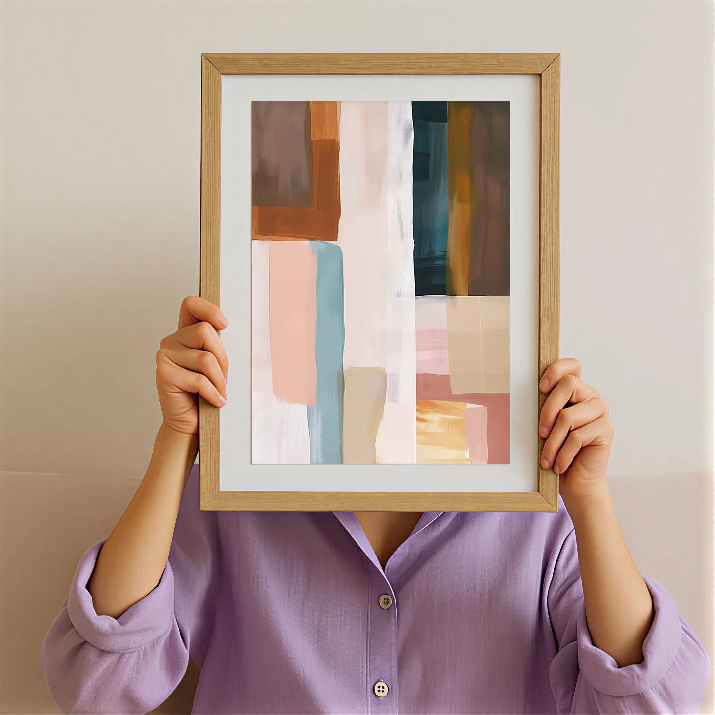 Person holding a framed abstract art piece against their face on a plain background