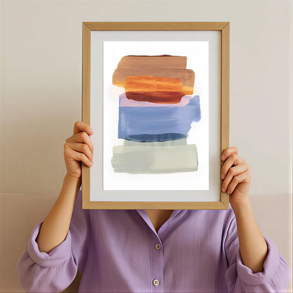 Person holding a framed abstract art print with a neutral background
