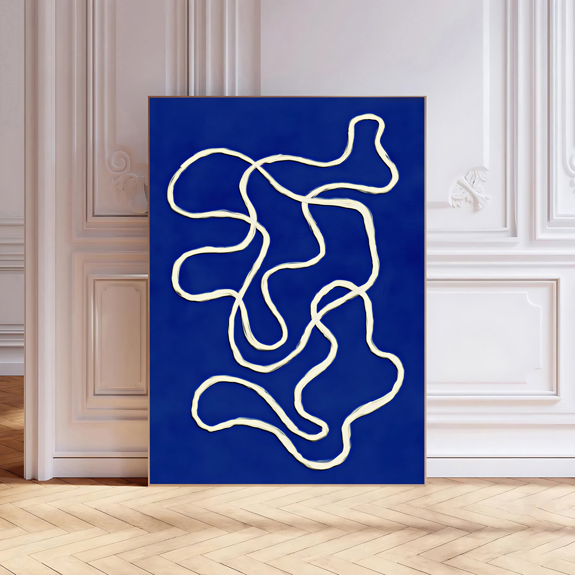 Abstract art print with white lines on a blue background in a room with white walls and wooden floor.
