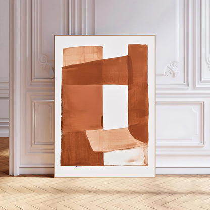 Abstract art print in a white frame on a wall with wooden flooring.
