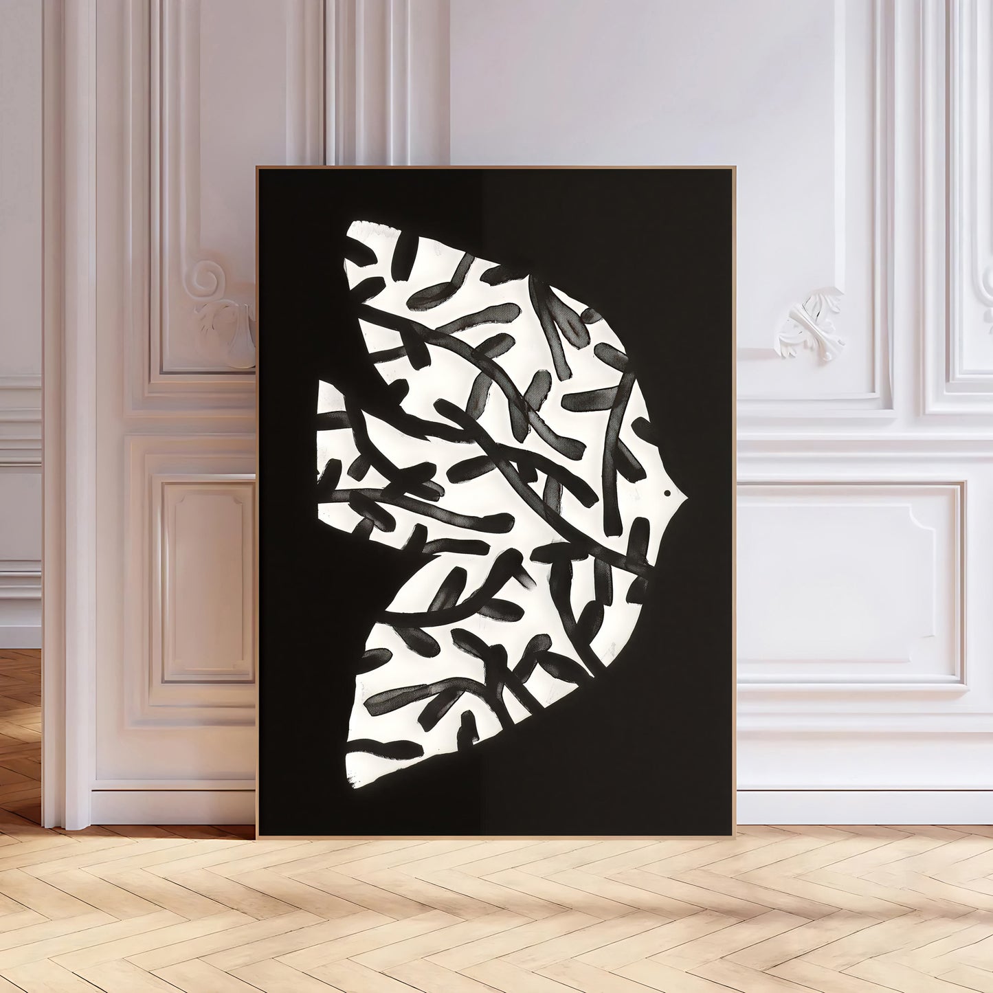 Abstract black and white artwork on a black background in a room with white walls and wooden floor.