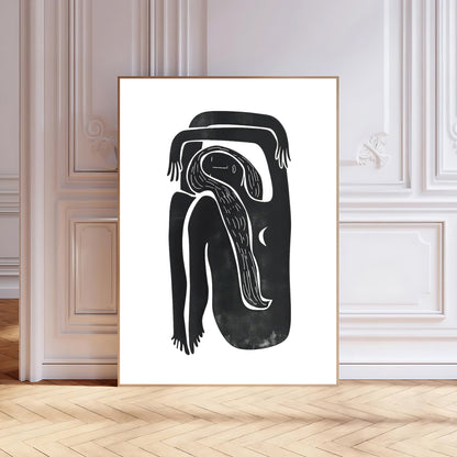 Framed black and white abstract artwork on a wall with wooden flooring.