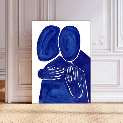 Abstract art print of two blue figures embracing on a white background, framed in a modern interior setting.